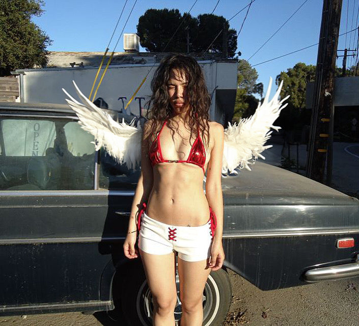 Unity Art Club model with angel wings in front of a car